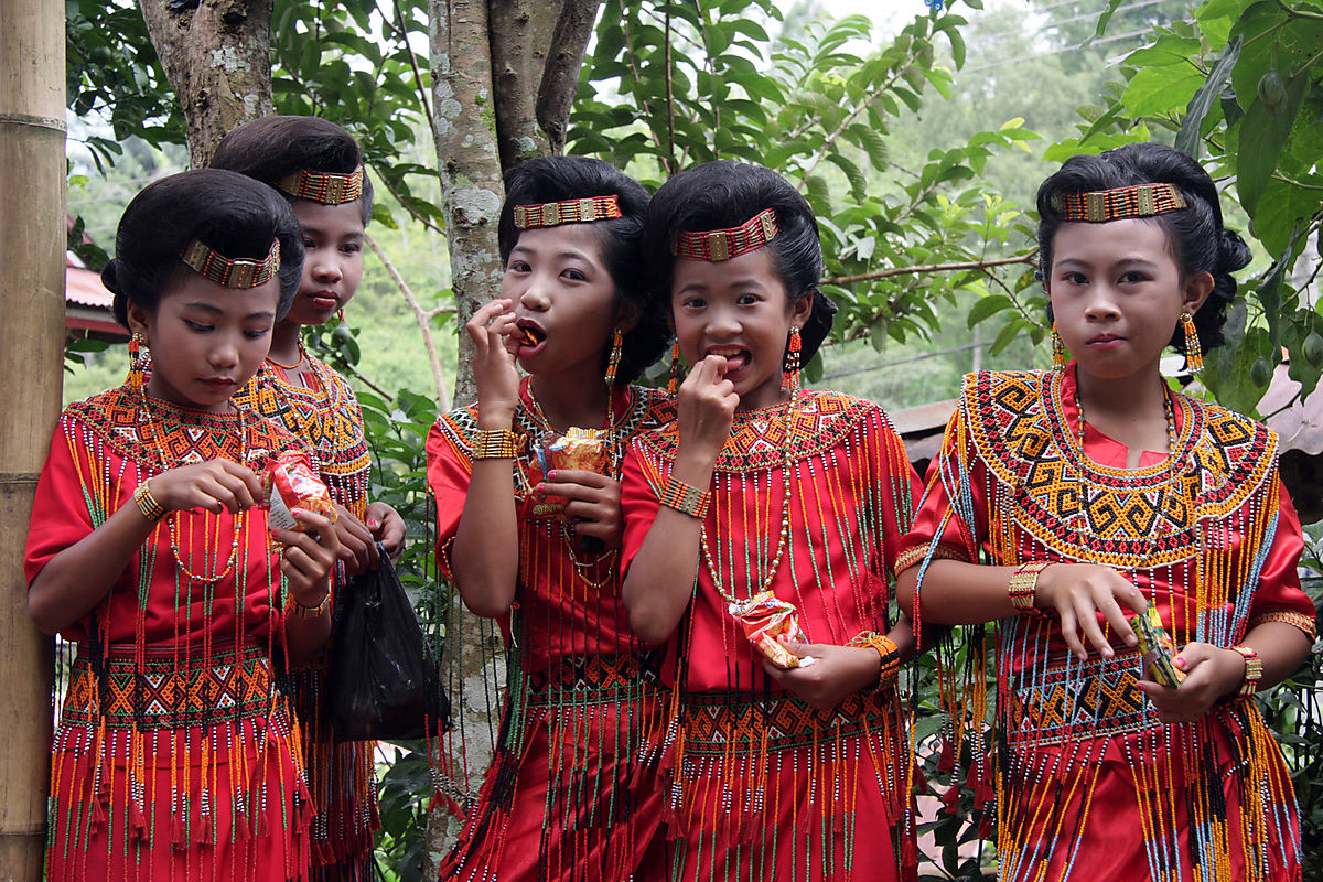 Young Torajan girls welcoming guests to a wedding on the island of Sulawesy